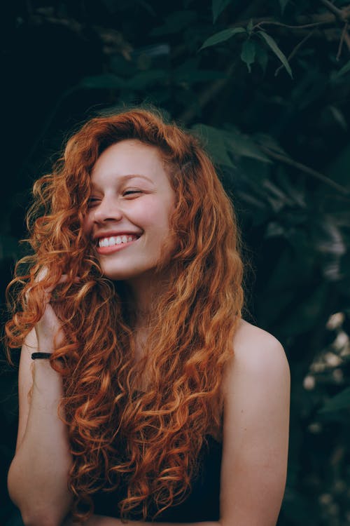 A smiling 12 year old girl with long natural hair poses for a vertical  photo suitable for text 27184051 Stock Photo at Vecteezy