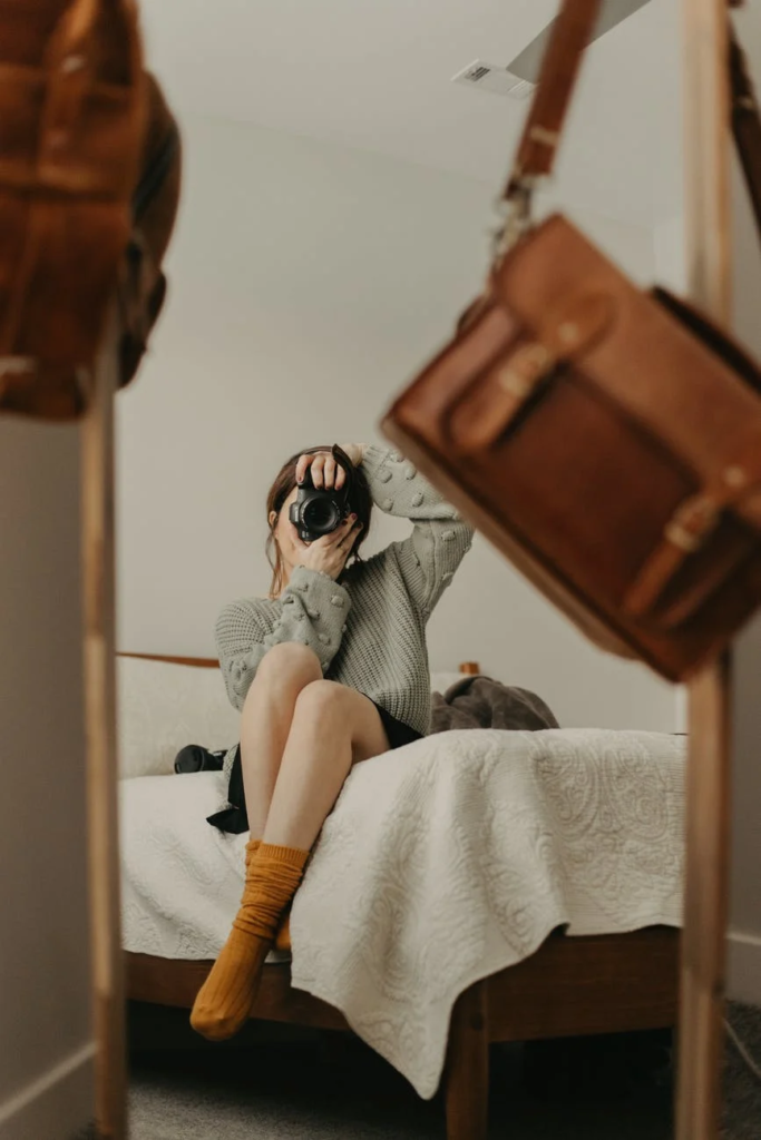 Cute Pose. Pretty Teenage Girl Sitting On The Bed In Her Room And Showing A  V Sign, Posing While Taking A Selfie Stock Photo, Picture and Royalty Free  Image. Image 94721158.