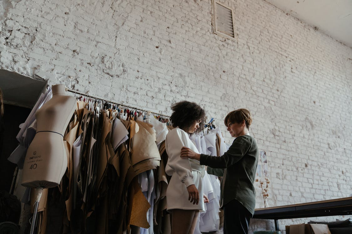 Fashion designer working studio interior with workplace table, fabric  materials and sewing patterns for clothes designing, tailoring. Atelier  workshop space. Small business and self employment concept Stock Photo