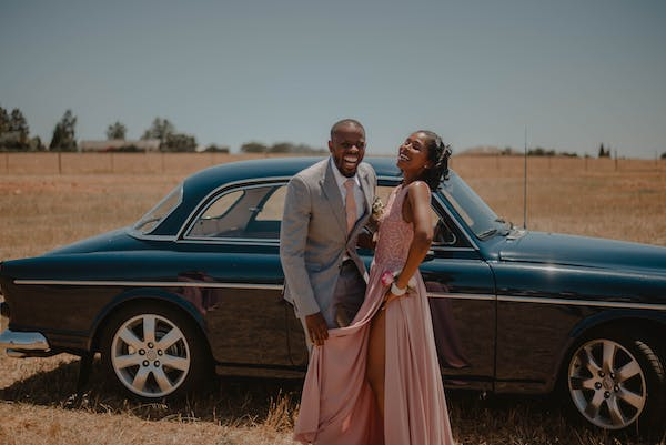 Beautiful wedding couple posing near the car in forest Stock Photo - Alamy