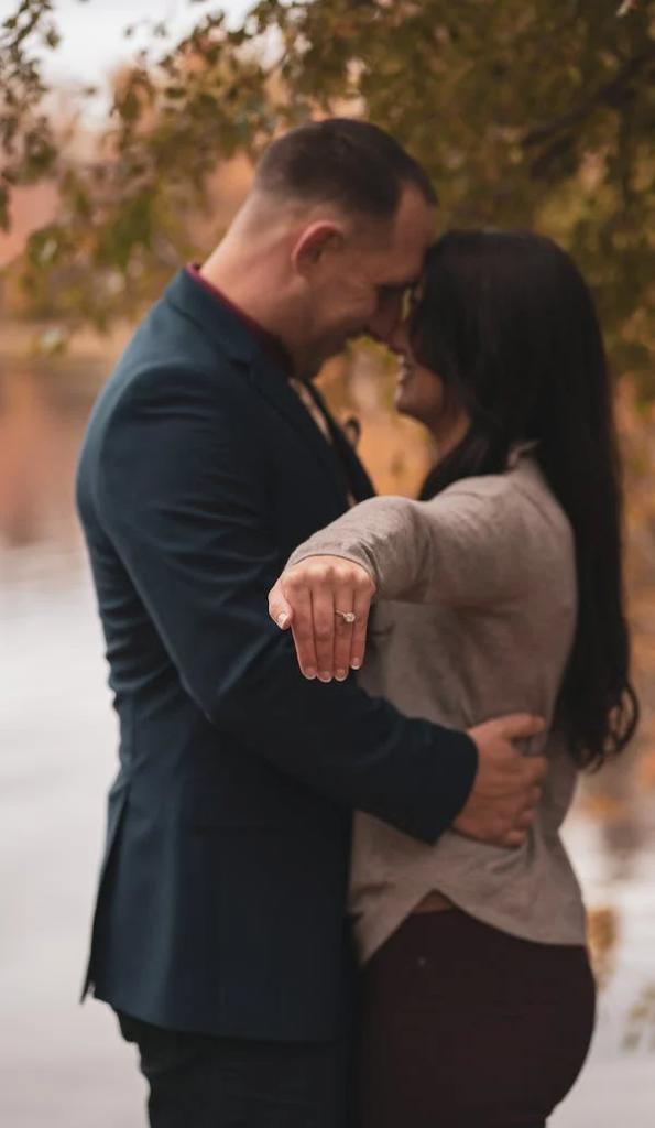 Premium AI Image | a young couple in formal wear posing for a photo.