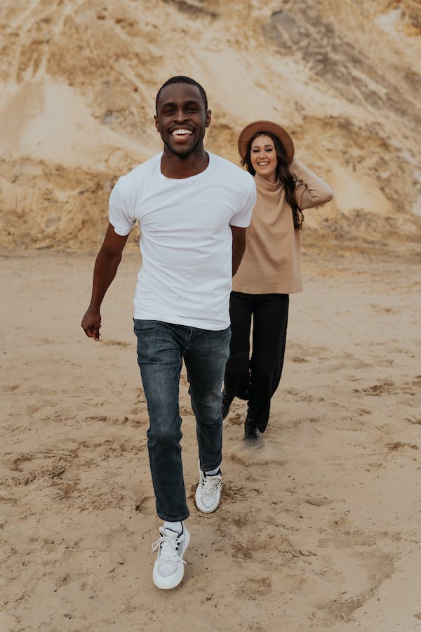 Happy traveling couple standing in desert - a Royalty Free Stock Photo from  Photocase